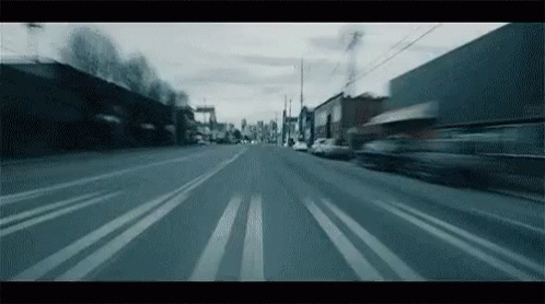 Animated gif. Timelapse film of driving through streets from the driver's perspective