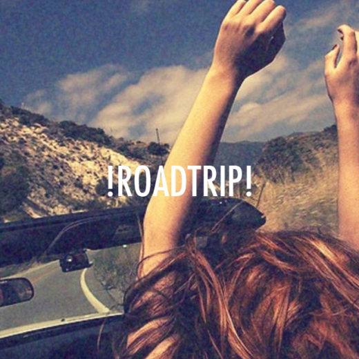 A woman in a car has her hands joyously in the air. Text over the picture sayd !Roadtrip!